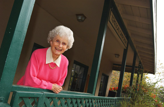 Palisadian author Betty Lou Young stands on the porch of the original meat market that was located in the Palisades Chautauqua Assembly Camp in Temescal Canyon and today serves as the State Park office.