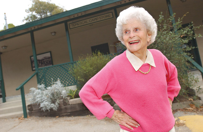Pacific Palisades historian Betty Lou Young stands in front of the original meat market that was located in the Palisades Chautauqua Assembly Camp in Temescal Canyon and today serves as the State Parks office.