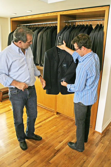 Mike Mangimelli, co-owner of BOCA Man, and his nephew, store manager Will Mangimelli, examine the fabric on their new line of custom-made suits.