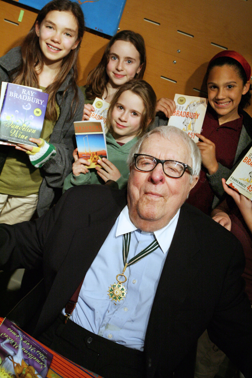 Seven Arrows Elementary School sixth grader Sophia Cardenas, fifth grader Sophia Kitay, first grader Sarah Kitay, and sixth grader Patricia Riches stand behind Ray Bradbury. Riches introduced her literary hero before a packed Palisades Public Library crowd.  Rich Schmitt/Staff Photographer