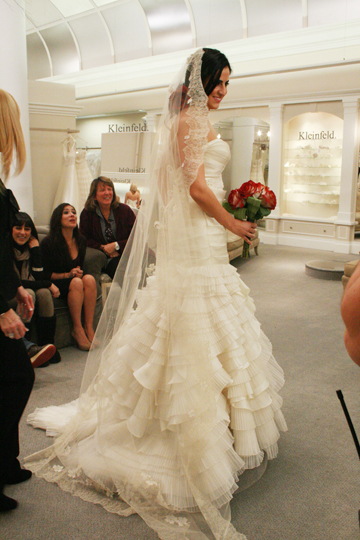 Sahar Atarzadeh tries on a Lazaro wedding dress.