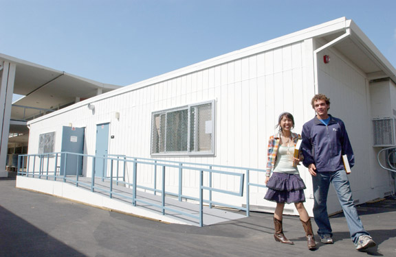 PaliHi students Ruby Gania and Adam Cristiano leave one of the school's new 14 classrooms. The school spent more than $700,000 on the rooms, which are equipped with new furniture and air conditioners.