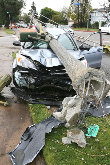 The driver of this Honda CR-V crashed into a traffic light pole at Sunset and Drummond about 9:30 p.m. Sunday, but escaped with only minor injuries. Rich Schmitt/Staff Photographer
