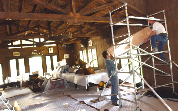 Curator Bruce Stiny and State Parks intern Michael Pujals work to reinstall the interior features of Will Rogers' living room as close as possible to the way it looked in 1930.