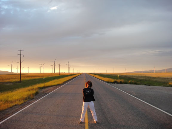 Maiya Verrone poses on a two-lane road near a wind farm in Judith Gap in Big Sky Country.