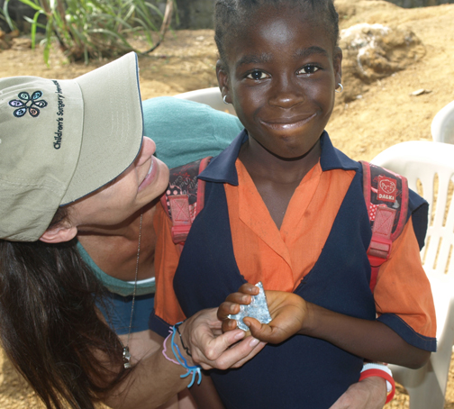 Marlene, an orphan in Liberia, treasures her broken mirror, joined by Palisadian Jennifer Malaret.