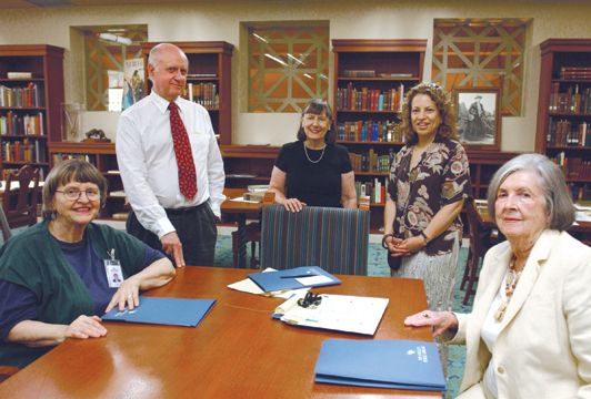 Culinary Historians of Southern California members Charles Perry, president, and Palisadian Helen Nielsen Allen, public relations, (foreground at right) rely on the resource specialists at the Central Library, including, from left Billie Connor-Dominguez, department manager and library liaison with CHSC; Helen Haskell, subject specialist; and Sheila Nash, senior librarian.