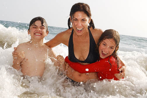 Palisadian and Heal the Bay board member Lisa Boyle splashes in the ocean at Will Rogers beach with her children Jake, 7, and Lili, 9.