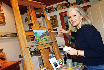 Painter Judith Howells at work in the studio of her Huntington Palisades home.