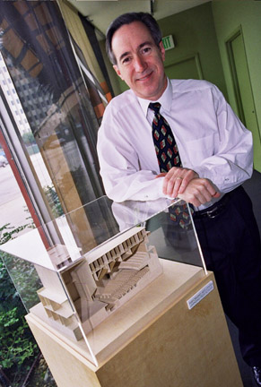 Palisadian J. Peter Devereaux stands over a Fields Devereaux model of Lawndale High School Performing Arts Center, 	currently under construction.