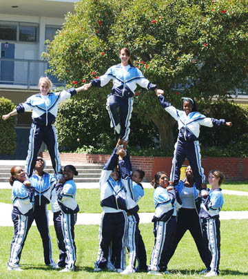 PaliHi cheerleaders, wearing their warm-up suits, create a pyramid. The 
