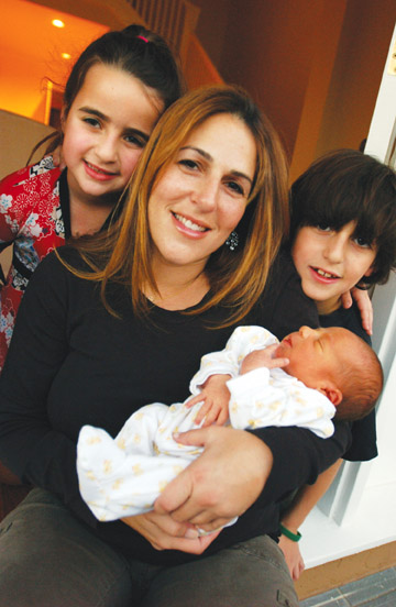 Week-old Caden Marc Ezralow is the Palisades First Baby of 2007. He is held by mom Gayle and surrounded by his siblings Riley (left) and Bryce.