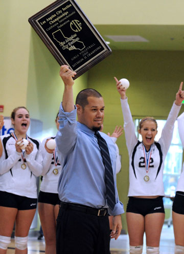 Head coach Chris Forrest holds the City championship trophy after his Dolphins won the girls title in November 2010. Rich Schmitt/Staff Photographer
