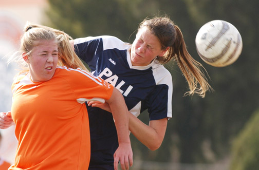 Kelly Mickel (right) of Palisades heads the ball away from a defender during the Dolphins