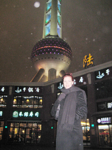 Sybil Grieb in front of a distinctive landmark in the Shanghai skyline: the 1,535-ft. Oriental Pearl TV Tower in the busiest part of Pudong New Area. Completed in 1994, it is the highest structure in Asia.