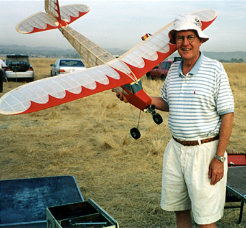 Norman Kramer and one of his hand-crafted model airplanes.