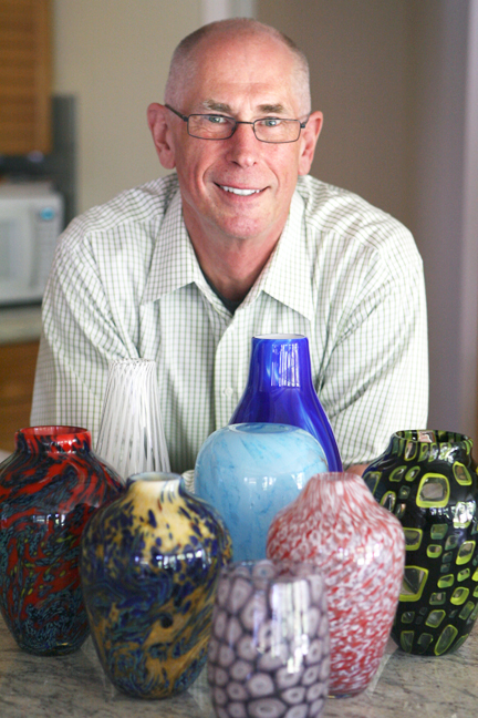 Glassblower Serge Lashutka at his Pacific Palisades home with samples of his work.