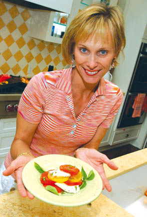 Food stylist Diane Elander prepares a summer Caprese salad in her kitchen. 