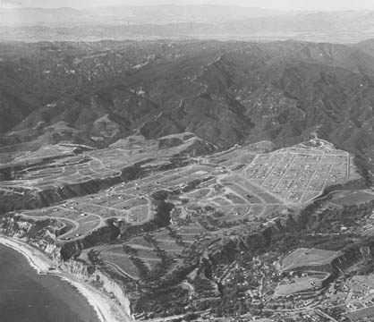 Aerial view of the Palisades taken in December 1927. Note the circular pattern of the streets in the Huntington Palisades, south of Potrero Canyon. Also, note the white house, the first in the neighborhood, which still stands today (see below). 	 Photo: Courtesy Pacific Palisades Historical Society