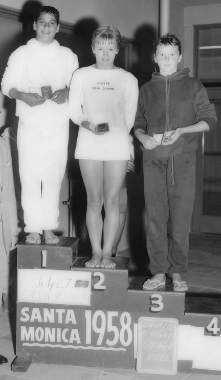 Maggie Gilbert (left), then 12, receives her gold medal for winning the 100-meter novice freestyle at the 1958 Junior Olympics in Santa Monica. The Palisades Charter High School's aquatic center, set to open in June, will be named after her.
