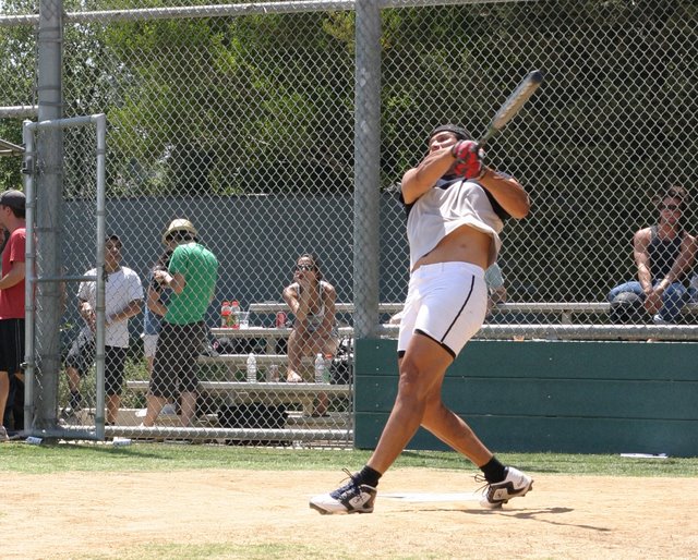 Jose Canseco uncorks one of his vaunted home runs at the Field of Dreams. He hit several balls into the parking lot. Photo: Dong Jun