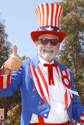 Pastor Wally Mees, resembling a blend of Uncle Sam and Abraham Lincoln, led the Palisades Lutheran Church parade entry. Mees is also president of the Palisades Optimist Club. Also, Five young spectators enjoyed watching the parade from their curbside seats.