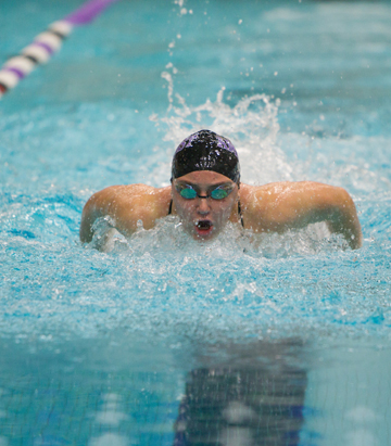 Amherst freshman swimmer Allison Merz races the 50-yard butterfly at a home meet against Hamilton College in January. Photo: Amherst College Sports Information