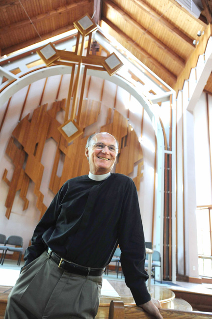 St. Matthew's Pastor Howard Anderson prays and preaches in the church sanctuary, the award-winning Moore Ruble Yudell structure that was consecrated in 1984.