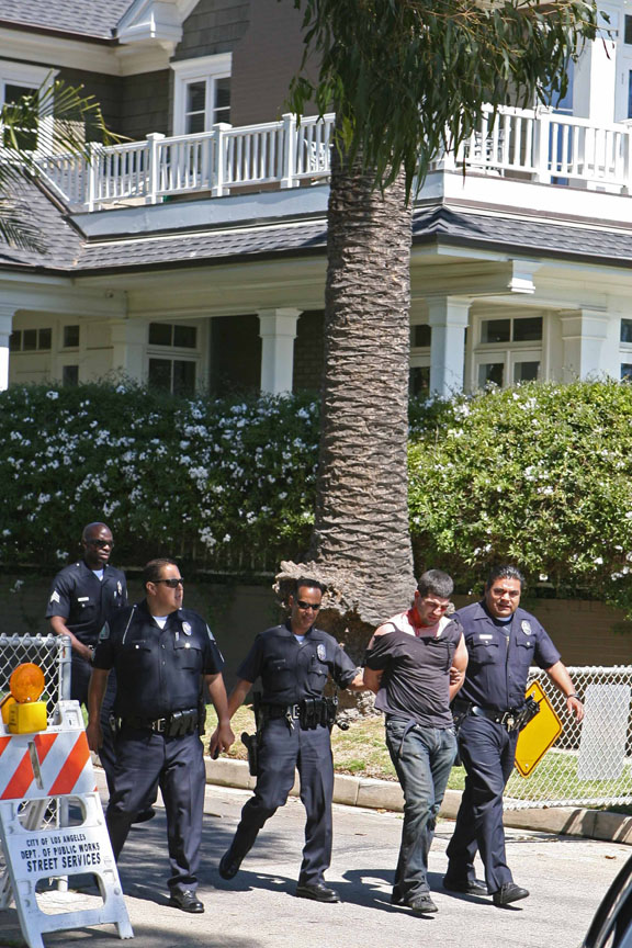 The driver of a high-performance Suzuki motorcycle, who led police on a high-speed chase into Pacific Palisades Monday afternoon, is taken away in handcuffs following his capture in the 300 block of Swarthmore (near the Via de las Olas bluffs).