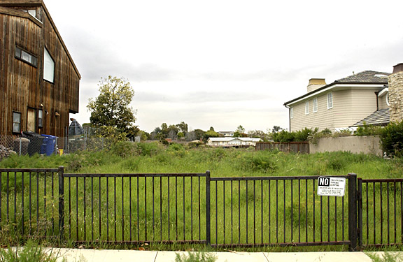 On the Rim of Potrero Canyon: In the 15,000 block of De Pauw Street, a city-owned lot is flanked by a recently constructed private home and a home owned and leased by the city.  Questions have been raised about the stability of the city lots.
