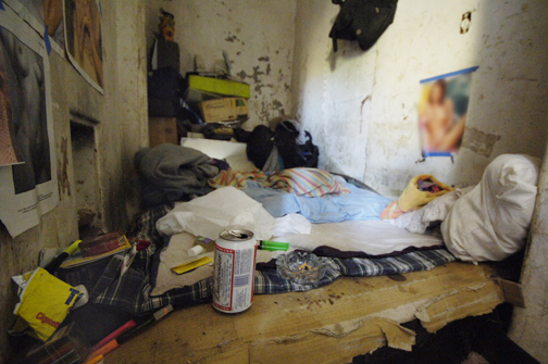 Inside a cement bunker tucked into the hillside near at the base of Potrero Canyon, a transient has transformed this small room into a bedroom.