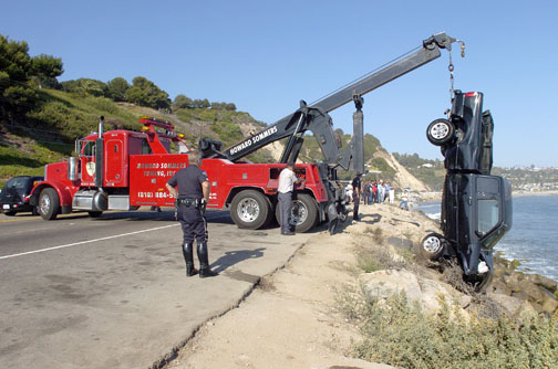 A tow truck blocked two lanes of traffic while extricating a pickup that crashed Tuesday afternoon on PCH near Sunset. Photo by Matt Wilken/Hot Shot News Service