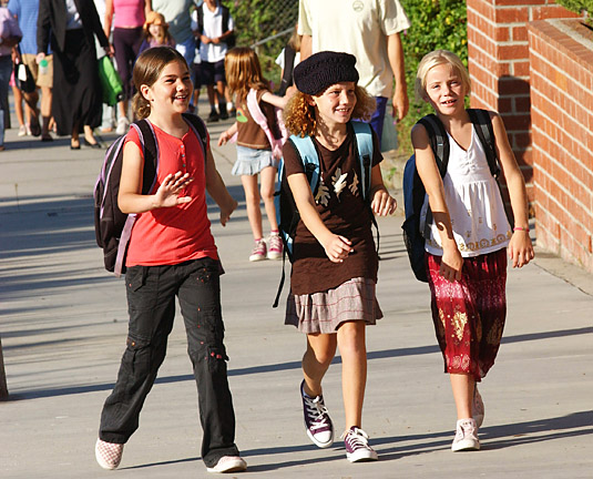 Marquez fourth graders Ava Giglio (center) and Hanna Ghadessi (left) headed to class with their friend, as other students poured in behind them.