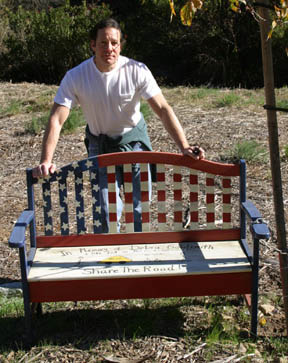 Palisades Honorary Mayor Steve Guttenberg at the memorial bench on Palisades Drive to honor cyclist Debra Goldsmith, who died after being struck from behind by an SUV in 2001.