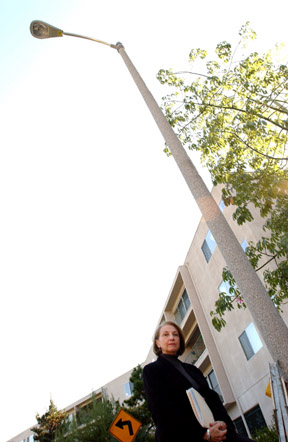 Paula Williams, under the light that residents of Ocean Woods Terrace Condominiums thought they voted not to have installed. Now that it's installed, but hasn't been turned on, residents are looking for answers from the City.