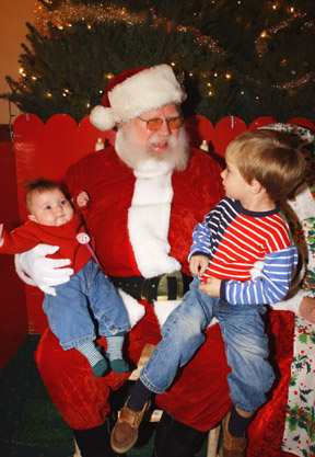 Callie Davis, 3 months, listened quietly as her 3-year-old brother, Tot, told Santa his Christmas wishes at last Friday's Holiday Ho!Ho!Ho! (Hopefully Tot remembered to make a wish for Callie, too.)