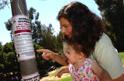 Park neighbor Karen Weber first saw this sign warning of West Nile virus last week while walking her 11-month-old daughter, Tamar, at the Palisades Recreation Center.