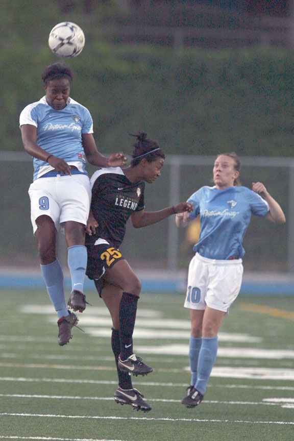 Danesha Adams (left) heads ball away from Legends