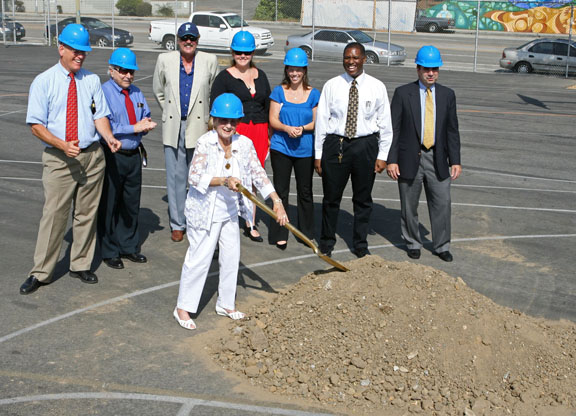 English teacher Rose Gilbert, age 90, is ready to dig with the help of (left to right) City Councilman Bill Rosendahl, American Legion Commander Lee Barkesdale, PaliHi facilities director Chaz Yench, swim coach Maggie Nance, executive director Amy Held, principal Martin Griffin and chief business officer Greg Wood.