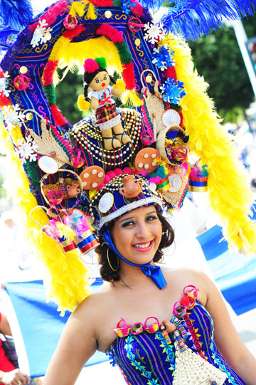 Several women wearing colorful headdresses led the way for a popular band that flew here from Guatemala. Photo by Rich Schmitt, Staff Photographer