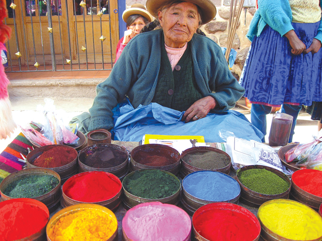 One of the many bold images by Lise Luttgens in the show is this photo of a blind woman selling natural dyes at the Sunday market in Pisac. Photo: Lise Luttgens.