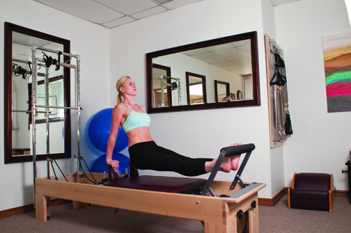 Lisa Corpin, owner of Pacific Coast Pilates, demonstrates Pilates techniques.