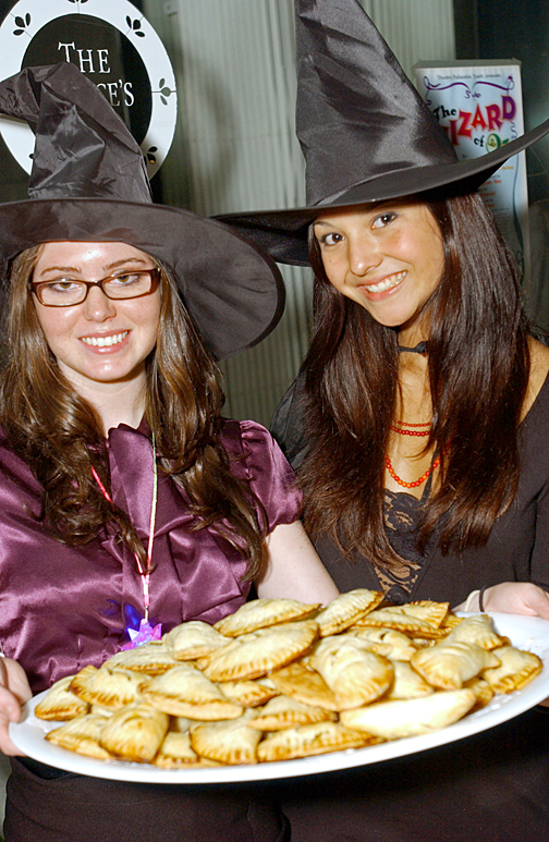 Elizabeth Tauro (left) and Jaki Doyka offer pumpkin pasties to customers waiting to purchase the seventh and final Harry Potter book. Two tables of donated goodies, including cockroach clusters, cookies, cupcakes and butterbear were available to the almost 500 people lining Swarthmore Avenue.