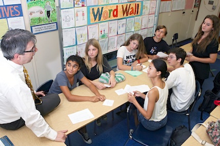 Paul Revere Middle School journalism advisor Eric Wechsler discusses upcoming stories with (clockwise from left) Bettina Papageorge, Julia Monkarsh, Caroline Bamberger, Harrison Larkins, Sophie Krasny (standing), Sam Harrison and Shannon Lee.           Rich Schmitt/Staff Photographer