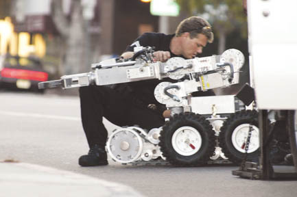 An LAPD bomb squad officer unloads the unit's remote-controlled robot, used to handle and move suspicious devices.  Photo: Morgan Genser