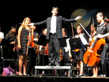 Paul Revere eighth grader Joel Rosenthal conducts the 75-member Paul Revere Symphony Orchestra at the school's annual spring concert.