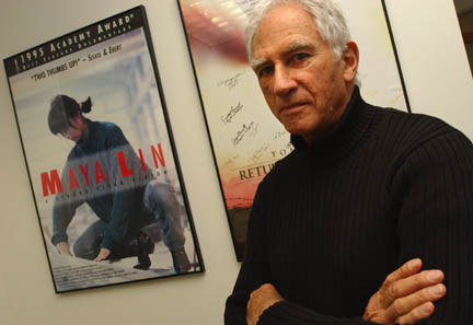 Palisadian Terry Sanders, president of the American Film Foundation, stands in his office in Santa Monica, surrounded by posters, including this one for the award-winning documentary on Maya Lin's Vietnam War Memorial.