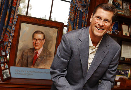 Bill Simon in the library of his home in the Huntington, where he lives with his wife Cindy and three of his four children. In the background is a painting of his father, Bill Sr., who passed away in June 2000 at the age of 72.