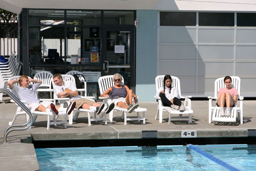 Friends of Temescal Pool co-founder Ilene Cassidy (center) is surrounded by Palisades High students as they relax in new lounge chairs purchased with a Friends' donation. Rich Schmitt/Staff Photographer