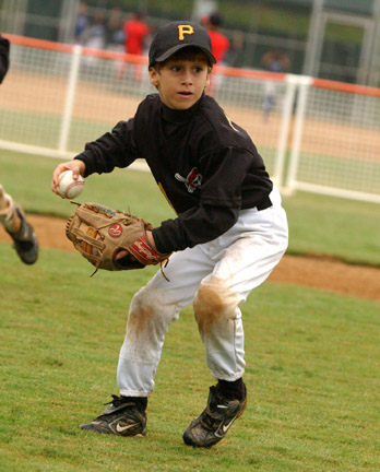 Pirates second baseman Michael Vastano gets set to throw a runner out at first base.